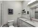 Bright bathroom featuring a stylish vanity, mirror, and a glass-enclosed shower at 8035 St Simons St # 8035, University Park, FL 34201