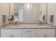 Bathroom with double sink vanity, modern fixtures, and neutral decor at 8035 St Simons St # 8035, University Park, FL 34201