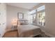 Light-filled bedroom featuring contemporary decor, bedside tables, and abundant natural light at 8035 St Simons St # 8035, University Park, FL 34201