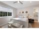 Bright bedroom with a comfortable bed, stylish bench, and large window offering natural light at 8035 St Simons St # 8035, University Park, FL 34201