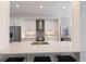 Bright kitchen with white cabinets, stainless steel appliances, and breakfast bar at 8035 St Simons St # 8035, University Park, FL 34201