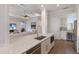 Kitchen featuring white cabinets, a breakfast bar, stainless steel appliances, and modern fixtures at 8035 St Simons St # 8035, University Park, FL 34201