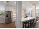 Modern kitchen with stainless steel appliances, quartz countertops, breakfast bar, and stylish backsplash at 8035 St Simons St # 8035, University Park, FL 34201