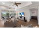 Spacious living room with tray ceilings, modern furniture, balcony, and hardwood flooring at 8035 St Simons St # 8035, University Park, FL 34201