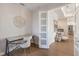 Bright home office showcasing natural light, stylish desk and chair, and an open doorway at 8035 St Simons St # 8035, University Park, FL 34201