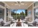 Inviting screened patio with comfortable seating and a ceiling fan overlooking lush greenery at 8035 St Simons St # 8035, University Park, FL 34201