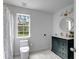 Bright bathroom featuring a dark vanity with brass fixtures at 20003 Holly Lake Pl, Lutz, FL 33558