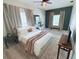 This bedroom has an accent wall, ceiling fan, and plush carpeting at 20003 Holly Lake Pl, Lutz, FL 33558