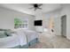 This bedroom has a carpeted floor, ceiling fan, and access to the backyard at 20003 Holly Lake Pl, Lutz, FL 33558