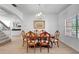 Dining room featuring a wood table, chairs, chandelier, and access to the staircase at 20003 Holly Lake Pl, Lutz, FL 33558