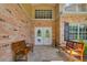 Inviting front entrance with double doors, brick accents, and benches for a welcoming arrival at 20003 Holly Lake Pl, Lutz, FL 33558