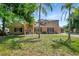 Two-story home with brick and siding exterior, complemented by palm trees and a well-manicured lawn at 20003 Holly Lake Pl, Lutz, FL 33558