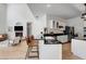 Bright kitchen featuring granite counters, modern appliances, eat-in bar and seamless flow into a vaulted living space at 20003 Holly Lake Pl, Lutz, FL 33558