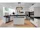 Bright kitchen features granite countertops, an island, stainless steel appliances, and modern lighting at 20003 Holly Lake Pl, Lutz, FL 33558