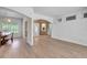 Open living room view with dining room and decorative arched entryway at 20003 Holly Lake Pl, Lutz, FL 33558