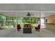 This covered patio features comfortable seating and a ceiling fan at 20003 Holly Lake Pl, Lutz, FL 33558