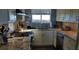 Modern kitchen features stainless steel appliances, granite countertops, and a window view at 5915 Sea Ranch Dr # 415, Hudson, FL 34667