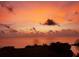 A fiery orange sunset view over the ocean, casting a warm glow on the horizon and sky above at 5915 Sea Ranch Dr # 415, Hudson, FL 34667