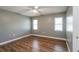 Bedroom featuring neutral walls, wood floors and two windows at 10237 Bannock St, Spring Hill, FL 34608