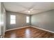 Bedroom featuring neutral walls, wood floors and two windows at 10237 Bannock St, Spring Hill, FL 34608