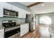 Well appointed kitchen featuring stainless steel appliances and ample natural light at 10237 Bannock St, Spring Hill, FL 34608