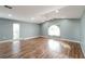 Bright living room featuring hardwood floors, large windows, and vaulted ceilings at 10237 Bannock St, Spring Hill, FL 34608