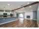Open living space with wood flooring, beamed ceilings, and kitchen view, perfect for entertaining at 10237 Bannock St, Spring Hill, FL 34608