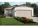 Charming single-story home with a neutral color scheme and beautifully landscaped front yard at 137 Whiteland Bnd, Nokomis, FL 34275