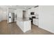 Modern kitchen with stainless steel appliances, white cabinets and a center island at 137 Whiteland Bnd, Nokomis, FL 34275