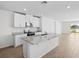 Modern kitchen with white cabinets, granite countertops, and stainless steel appliances at 137 Whiteland Bnd, Nokomis, FL 34275
