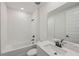Bathroom featuring modern sink, white tile bathtub, and black fixtures at 13839 Richland Gulf Cir, Parrish, FL 34219
