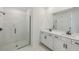 Modern bathroom with double sinks, quartz countertops, and a frameless glass shower at 13839 Richland Gulf Cir, Parrish, FL 34219