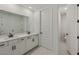 Bright bathroom featuring double vanity with stone countertop and a private toilet room at 13839 Richland Gulf Cir, Parrish, FL 34219