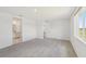 Bright bedroom with soft carpeting, a large window and easy access to ensuite bathroom at 13839 Richland Gulf Cir, Parrish, FL 34219