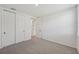 Bedroom featuring gray carpet, closet, and bright neutral paint at 13839 Richland Gulf Cir, Parrish, FL 34219
