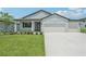 Charming home with a well-manicured lawn and a three-car garage at 13839 Richland Gulf Cir, Parrish, FL 34219