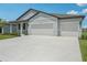 Charming single-Gathering home featuring a three-car garage and well-manicured lawn at 13839 Richland Gulf Cir, Parrish, FL 34219