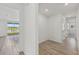 Hallway featuring tile flooring, bright neutral paint, and natural light at 13839 Richland Gulf Cir, Parrish, FL 34219