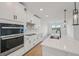 Bright kitchen boasting modern appliances, white cabinetry and quartz countertops at 13839 Richland Gulf Cir, Parrish, FL 34219