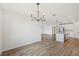 Open-concept living space featuring hardwood style flooring and modern light fixtures at 13839 Richland Gulf Cir, Parrish, FL 34219