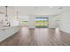 Bright living room with hardwood style flooring, lake view and modern light fixtures at 13839 Richland Gulf Cir, Parrish, FL 34219
