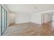 Expansive living room with wood-look tile and a sliding glass door at 13839 Richland Gulf Cir, Parrish, FL 34219