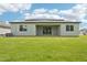 Spacious backyard with a well-maintained lawn, covered patio, and view of the home's rear at 14035 Kelly Park Ct, Parrish, FL 34219