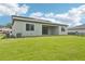 New home backyard featuring a well-maintained lawn, covered patio, and serene views of the surrounding landscape at 14035 Kelly Park Ct, Parrish, FL 34219