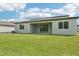 Backyard featuring a well-maintained lawn, covered patio, and view of the home's rear at 14035 Kelly Park Ct, Parrish, FL 34219