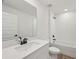 Bathroom featuring a tub, sleek vanity, toilet, mirror, and dark fixtures at 14035 Kelly Park Ct, Parrish, FL 34219