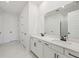 Modern bathroom with double sinks, white cabinets, and a glass-enclosed shower at 14035 Kelly Park Ct, Parrish, FL 34219