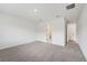 Bright bedroom with neutral carpet, a white wall, and two doors at 14035 Kelly Park Ct, Parrish, FL 34219