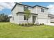 Two-story home with a manicured lawn, modern architectural design, and an attached three-car garage and landscaping at 14035 Kelly Park Ct, Parrish, FL 34219
