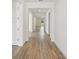 Inviting hallway with wood-look tile flooring, neutral walls, and clear sightlines into other rooms at 14035 Kelly Park Ct, Parrish, FL 34219